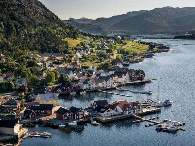 https://www.norway-adventures.com/wp-content/uploads/2022/11/Kalvag-fisherman-village-from-air-Photo-by-Knutholmen.jpg